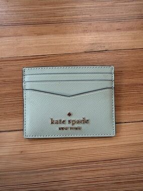 kate spade sage green leather card case with gold logo